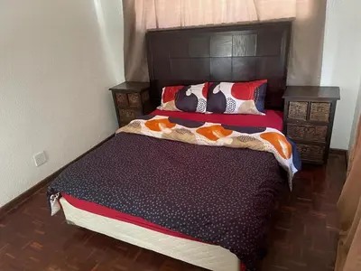 a bedroom with a large bed with pillows on it at House On Gill 3 in Cape Town