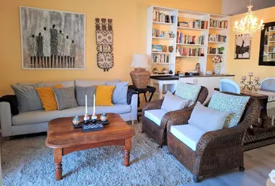 a living room with two couches and a coffee table at Franschhoek Wine Tram Apartment in Franschhoek