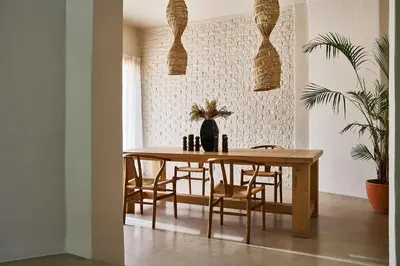 a dining room with a wooden table and chairs at Kokon Boutique Guesthouse in Somerset West