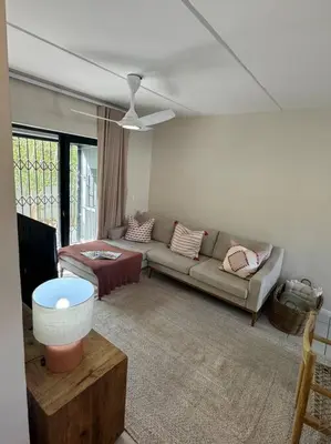 a living room with a couch and a tv at Slaap Self Catering in Paarl