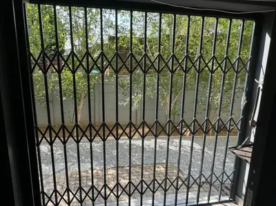 an iron gate with a view of a street at Slaap Self Catering in Paarl
