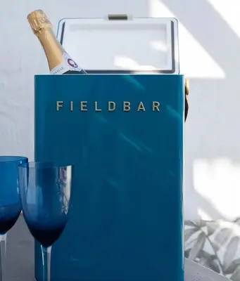a bottle of champagne in a blue box next to two glasses at Les Baleines Hermanus Villa in Hermanus