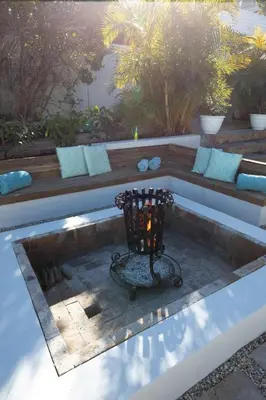 a patio with a bench with a candle in it at Les Baleines Hermanus Villa in Hermanus