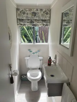 a small bathroom with a toilet and a sink at Moonshine in Hermanus