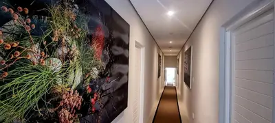 a hallway with a large painting on the wall at C'est la Vie 2 in Franschhoek