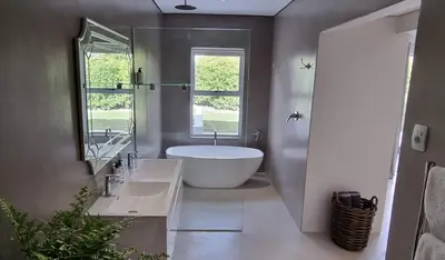 a bathroom with a large tub and a window at C'est la Vie 2 in Franschhoek