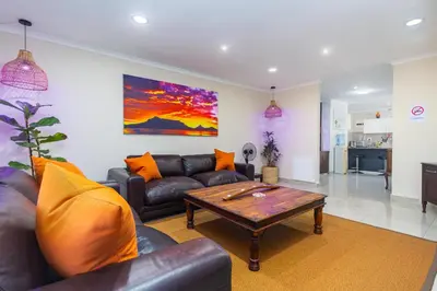 a living room with a couch and a coffee table at Ina se Huisie in Blouberg self Catering Apartment in Cape Town