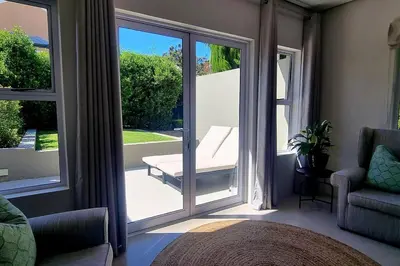 a room with a sliding glass door with a chair at C'est la Vie 4 in Franschhoek