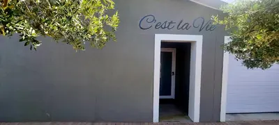 a sign that reads get in we on the side of a house at C'est la Vie 4 in Franschhoek