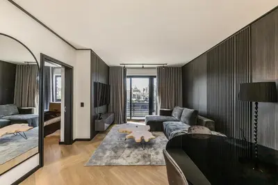 a living room with a couch and a table at The Archetype - Nine Palms Luxury Apartments in Cape Town