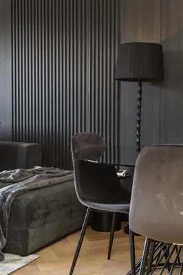 a bedroom with a chair and a table and a bed at The Archetype - Nine Palms Luxury Apartments in Cape Town