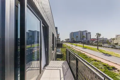 a balcony of a building with a view of a street at The Archetype - Nine Palms Luxury Apartments in Cape Town