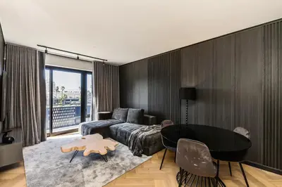 a living room with a couch and a table at The Archetype - Nine Palms Luxury Apartments in Cape Town