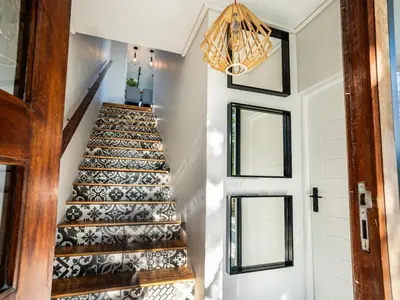 a staircase in a home with black and white tiles at In-a-Tree in Paarl
