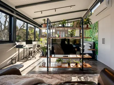 a living room with a lot of windows at In-a-Tree in Paarl