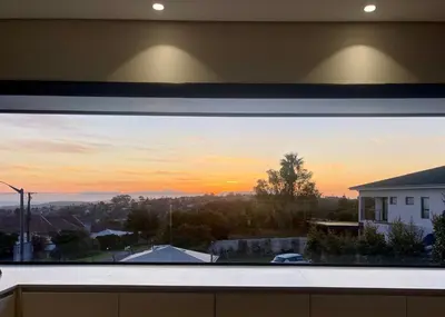 a view of a sunset from a window at The View in Cape Town