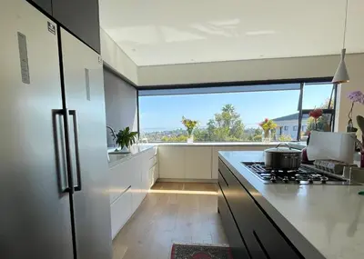 a kitchen with a stove and a large window at The View in Cape Town