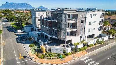 an aerial view of a white building with a street at Greystone Executive Apartments in Cape Town