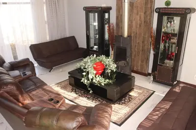 a living room with a couch and a flower on a table at Trinity in Cape Town