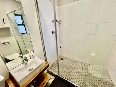 a bathroom with a sink and a shower at The Den at 41- Parking included in Stellenbosch
