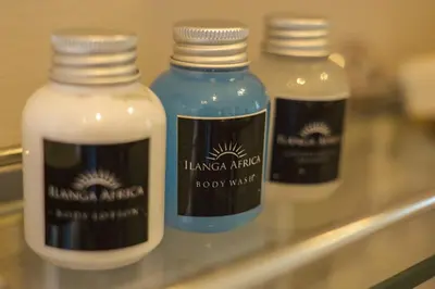 a group of three bottles of soap on a shelf at Ilanga Du Cap Hotel in Cape Town
