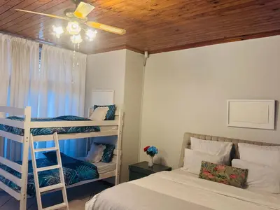 a bedroom with two bunk beds and a ceiling fan at Leisure Lodges Family Room Parow in Cape Town