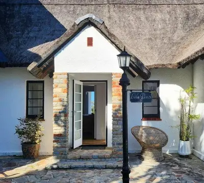 a house with a street light in front of it at Lala Panzi House - Grotto Beach, Voëlklip in Hermanus