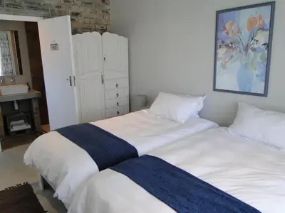 two beds sitting next to each other in a bedroom at Our Nest Guest House in Kleinmond