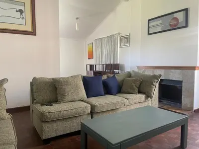 a living room with a couch and a table at Mary's Cape in Cape Town
