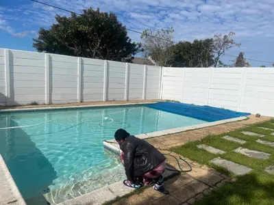a person standing next to a pool with a hose at Mary's Cape in Cape Town