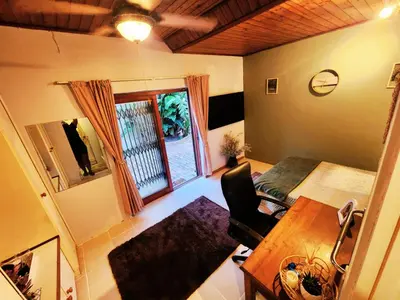 a living room with a table and a window at Budget Haven Durbanville in Cape Town