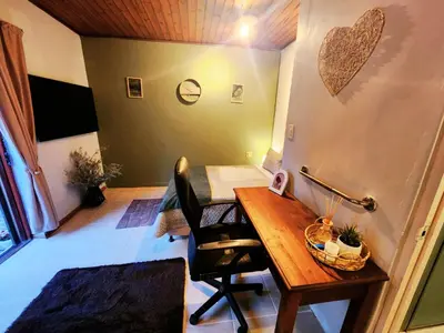 a small room with a desk and a chair at Budget Haven Durbanville in Cape Town