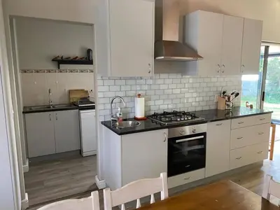a kitchen with white cabinets and a stove top oven at no 5 King Street, Onrus in Hermanus