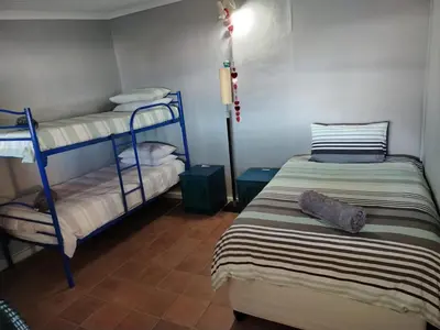 a room with two bunk beds and a lamp at Sunset Splendour in Pringle Bay
