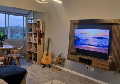 a living room with a flat screen tv on a wall at A Short Walk to the Cliffs in Hermanus