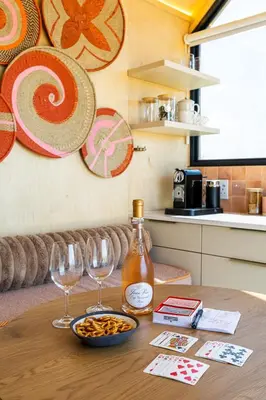 a table with two glasses and a bottle of wine at Stellenbosch Farm Cabin - Klein Frans in Stellenbosch