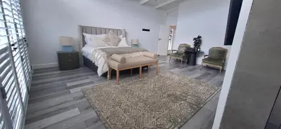 a bedroom with a bed and a rug at Comfort Cove in Cape Town