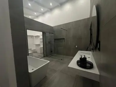 a bathroom with a tub and a sink and a bath tub at Comfort Cove in Cape Town