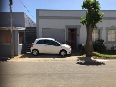 a white car parked in front of a house at The Pink Door in Caledon
