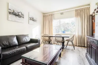 a living room with a couch and a table at Avemore Vredehof 1 with backup power in Stellenbosch