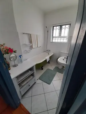 a white bathroom with a sink and a toilet at Local & comfortable in Mandalay