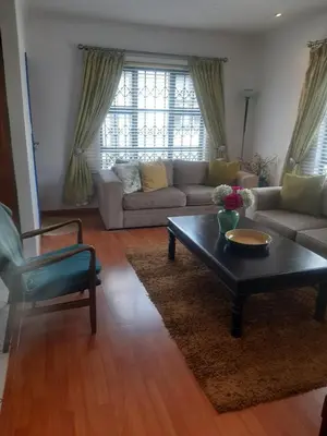 a living room with a couch and a coffee table at Local & comfortable in Mandalay