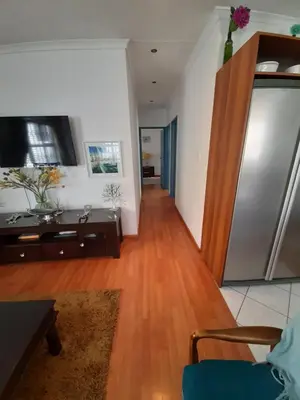 a living room with a refrigerator and a wooden floor at Local & comfortable in Mandalay