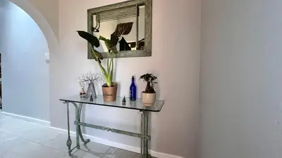 a table with plants and a mirror on a wall at NamaStay in Cape Town