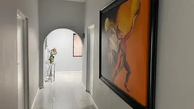a hallway with a painting of a woman on the wall at NamaStay in Cape Town