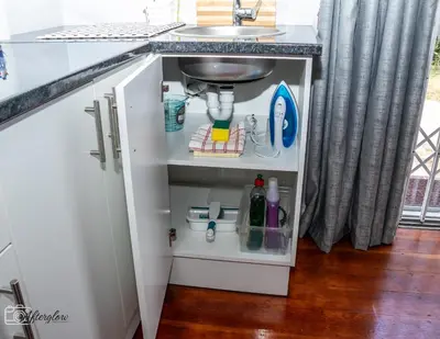 a kitchen cabinet with a sink under a counter at NamaStay in Cape Town