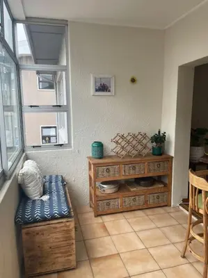 a living room with a bench and a table at The Beachside Nest in Cape Town