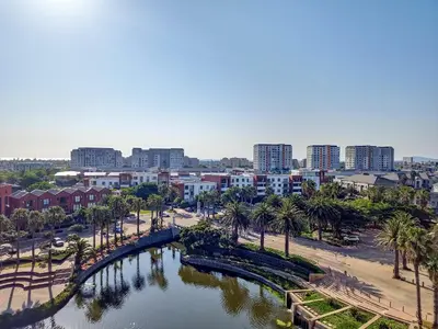a city with a river and palm trees and buildings at Canal, Mountains, Sea Views, Pool, Gym, Parking, Wifi in Cape Town