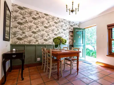 a dining room with a table and chairs at Keerweder Cottages in Franschhoek