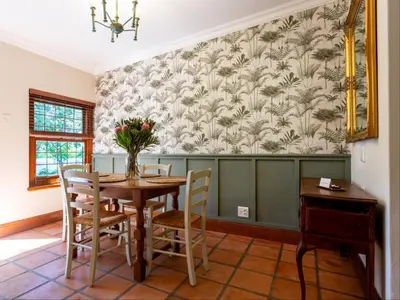 a dining room with a table and chairs at Keerweder Cottages in Franschhoek